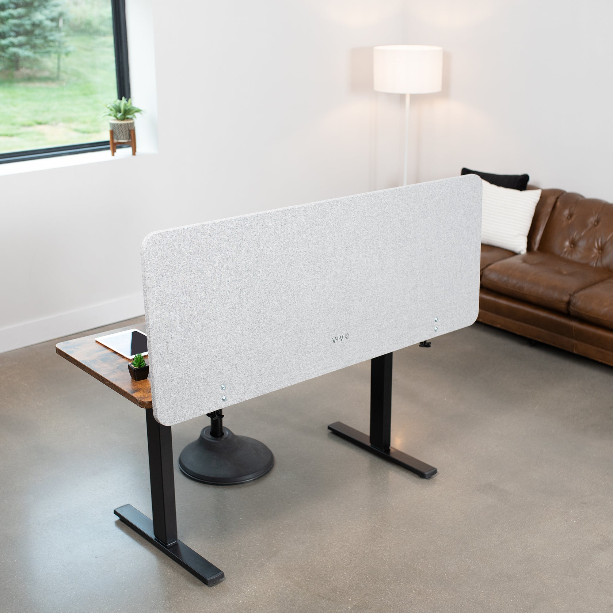 Clamp-on desk privacy panel for office workspace.