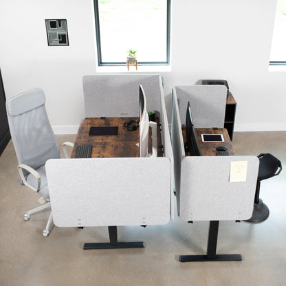 Clamp-on desk privacy panel for office workspace.