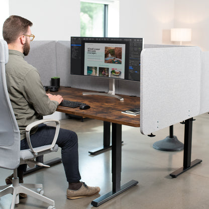 Clamp-on desk privacy panel for office workspace.