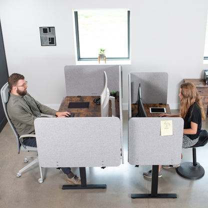 Clamp-on desk privacy panel for office workspace.