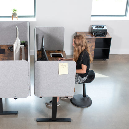 Clamp-on desk privacy panel for office workspace.