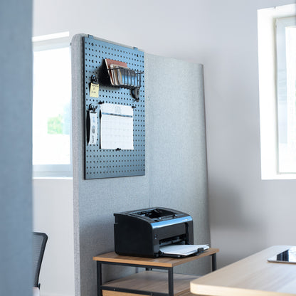 Printers on a wooden desk with a pegboard wall in an office setting