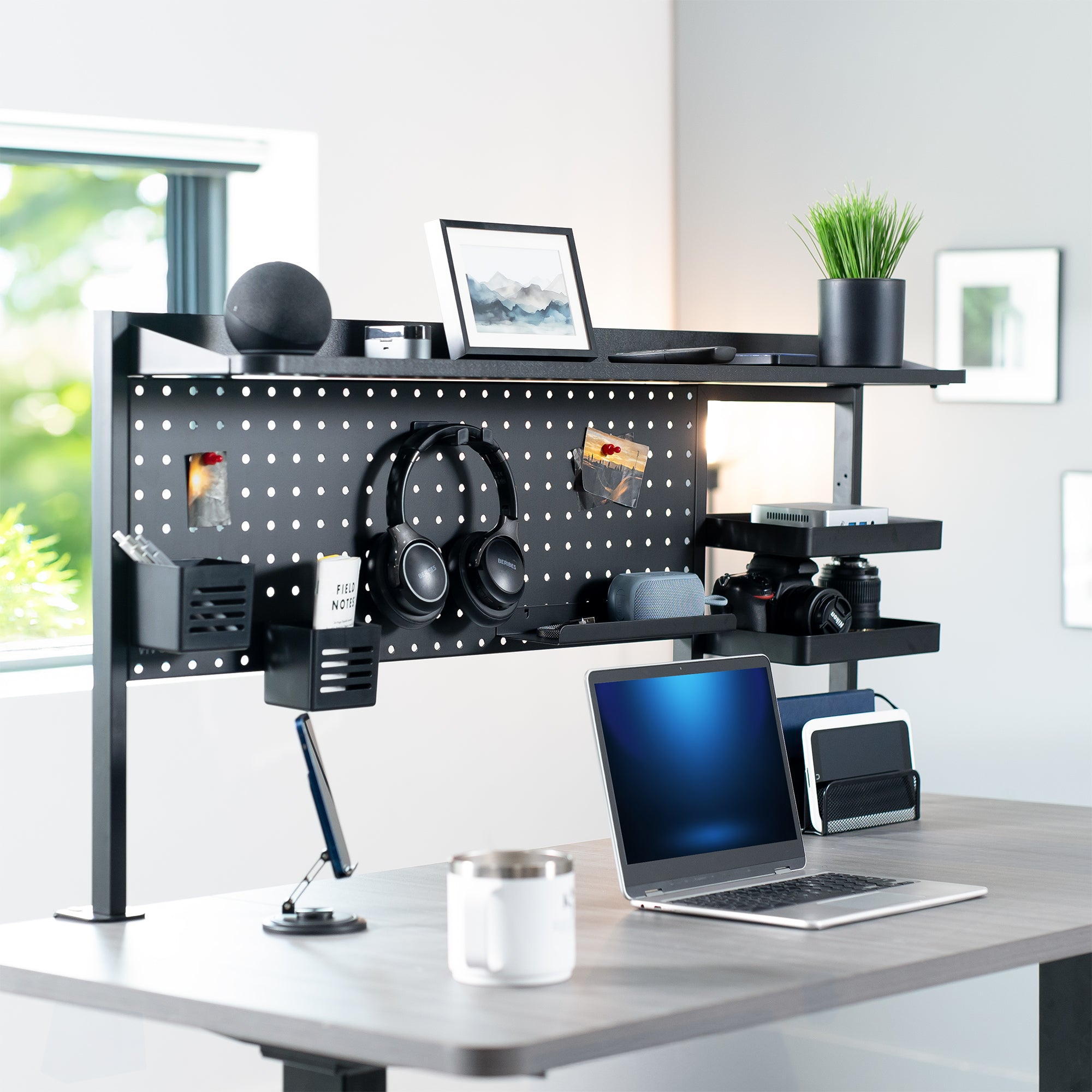Modern office setup with a standing desk, shelves, and computer equipment.