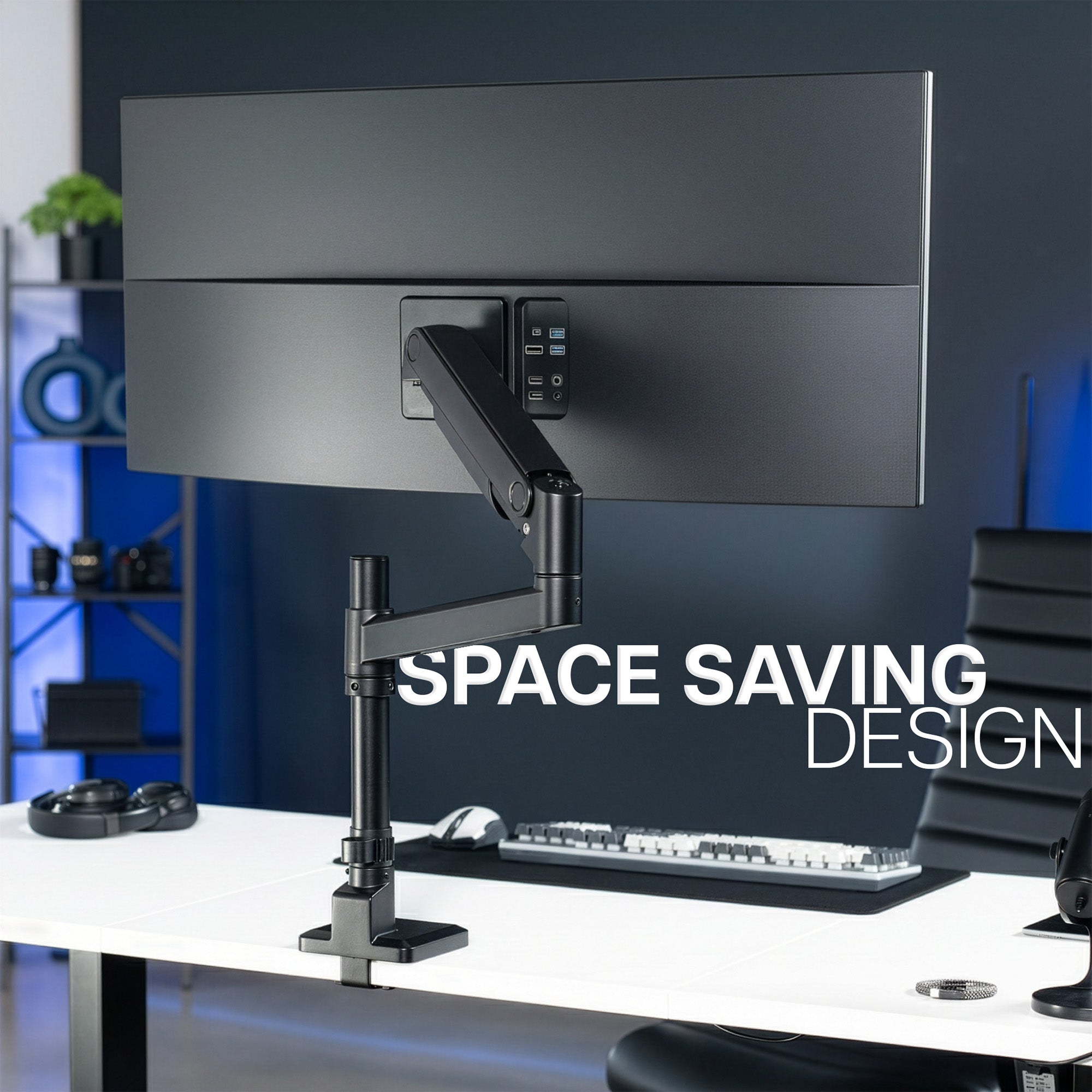 Space-saving monitor mount supporting an ultra wide monitor,  on a desk in an office setting.