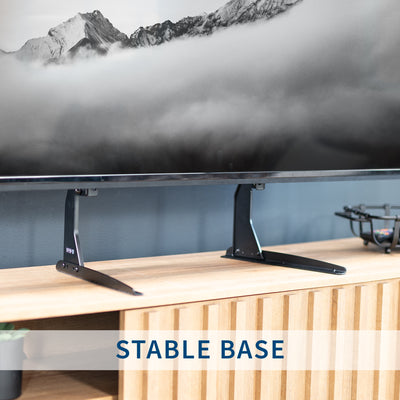 TV on a stable base with a mountainous landscape in the background