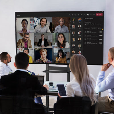 Mobile TV mount cart with media shelf and locking wheels. Stand features height adjustment, articulation, and a built-in cable management system.