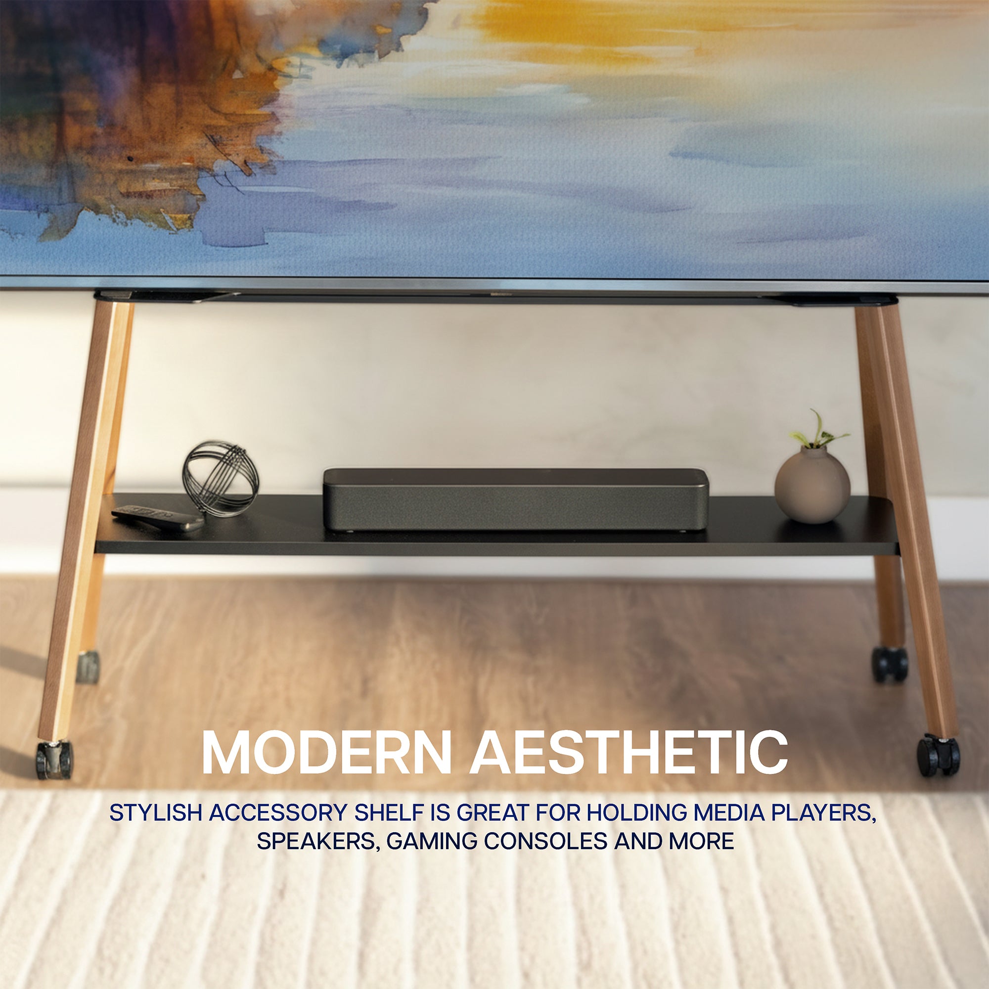 A modern TV stand with a black shelf and light wood legs on casters, shown holding a soundbar and decorative items. The image includes text overlays reading 'MODERN AESTHETIC' and 'STYLISH ACCESSORY SHELF IS GREAT FOR HOLDING MEDIA PLAYERS, SPEAKERS, GAMING CONSOLES AND MORE'.