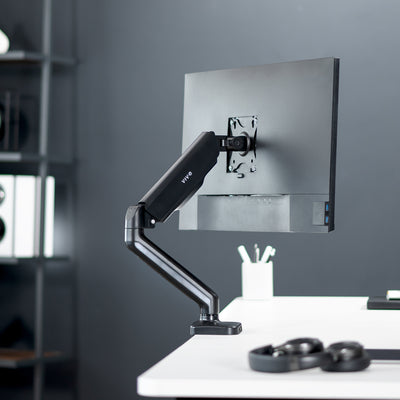 Sturdy clamp-on pneumatic arm single monitor desk mount with USB ports and audio ports, articulation, height adjustment, and cable management.