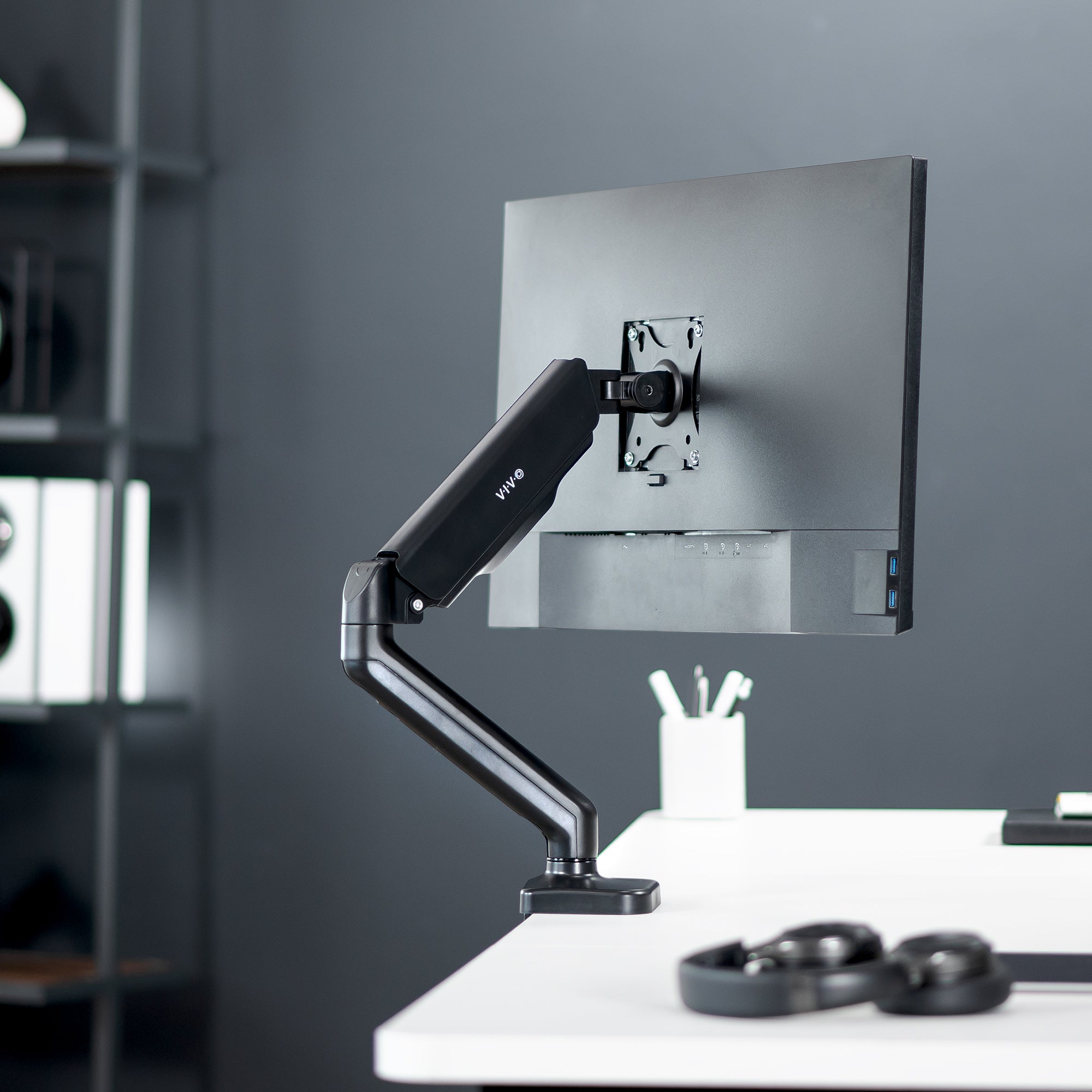 Sturdy clamp-on mechanical arm single monitor desk mount with articulation, height adjustment, and cable management.