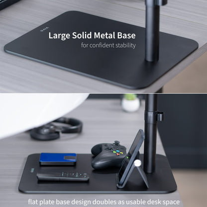 Black desk setup with large solid metal base and flat plate design on a desk.