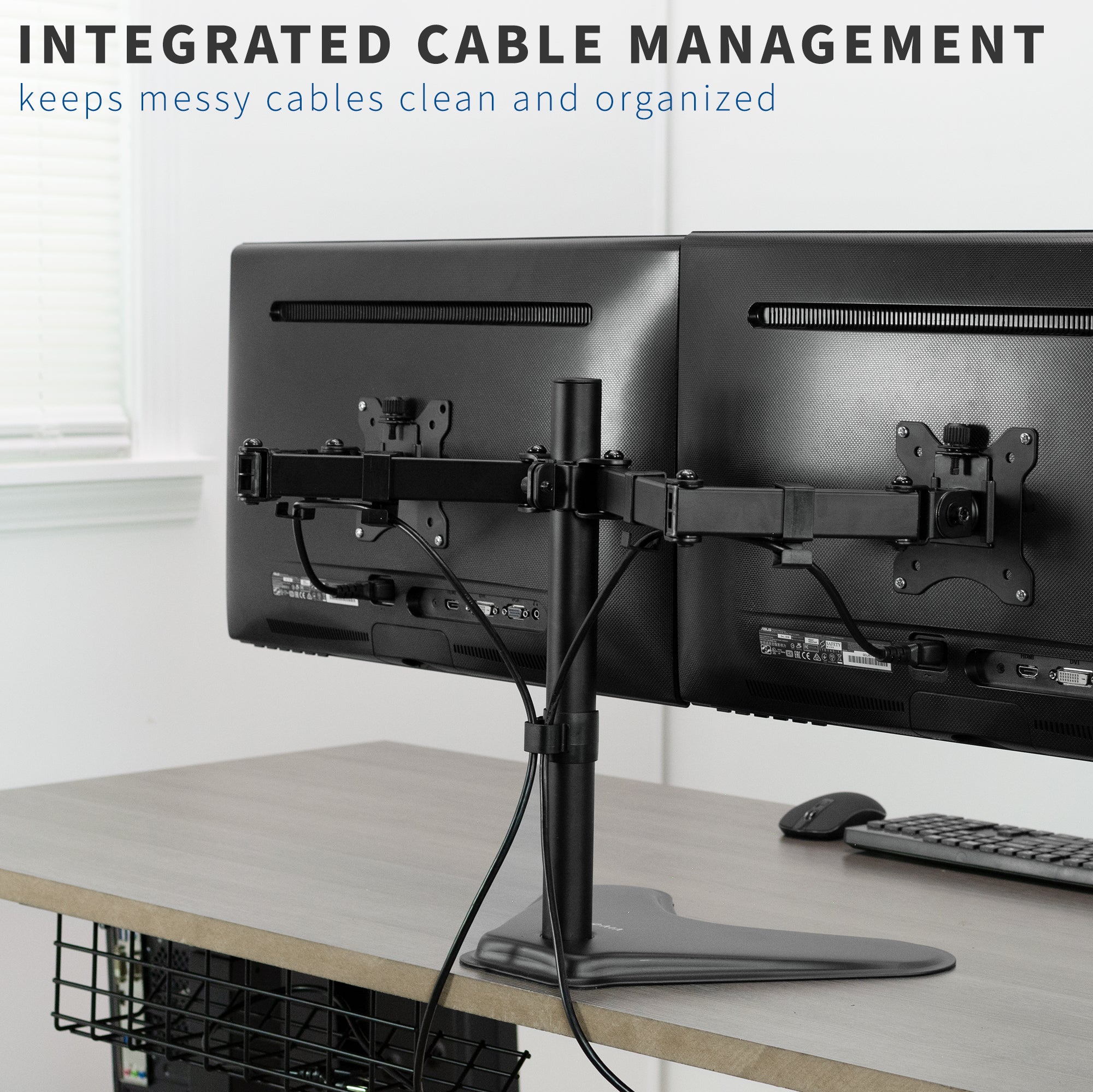 Dual monitor setup with cable management system on a desk.