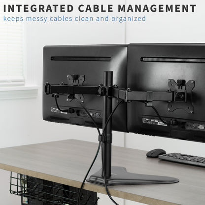 Dual monitor setup with cable management system on a desk.