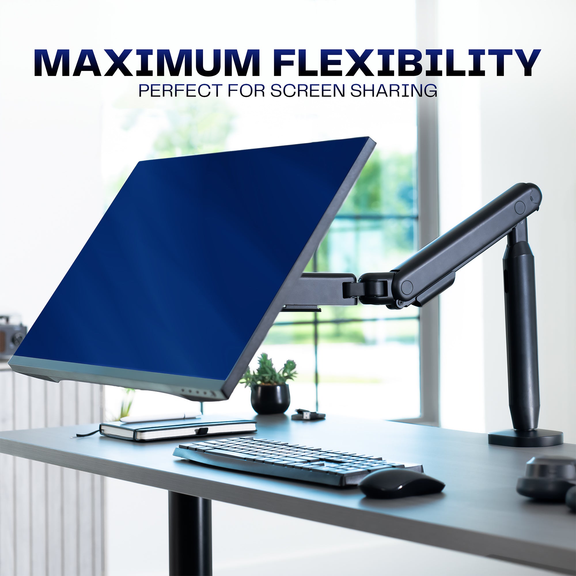Flexible monitor arm on a desk with text displaying flexibility. 