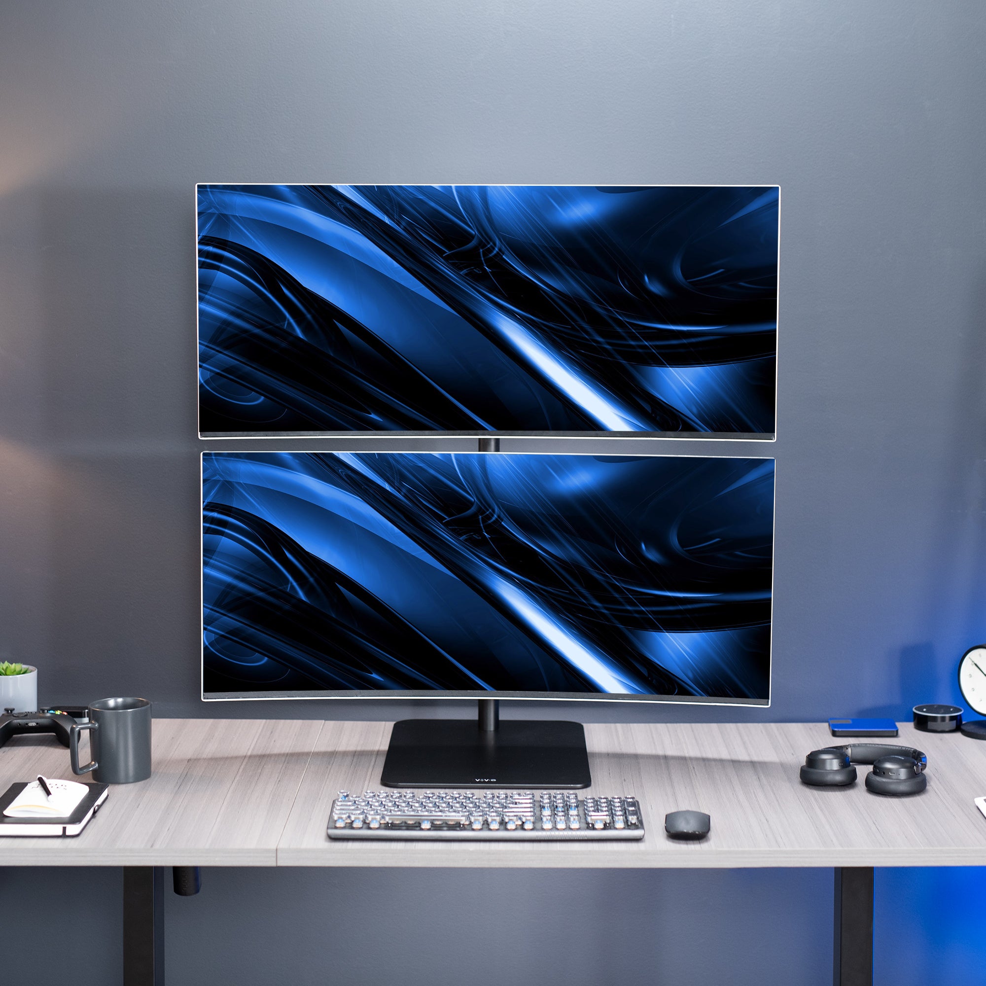 Dual Ultrawide Vertical Monitor Desk Stand elevates 2 large monitors in a vertically stacked array for comfortable viewing angles and efficient use of desk space. The freestanding base provides excellent support with no need to drill or clamp into your desktop.