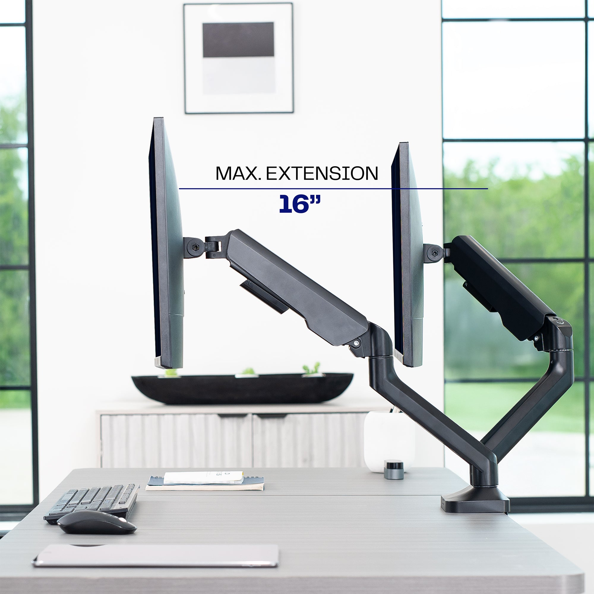 Monitor stand with dual monitor support on a desk in an office setting