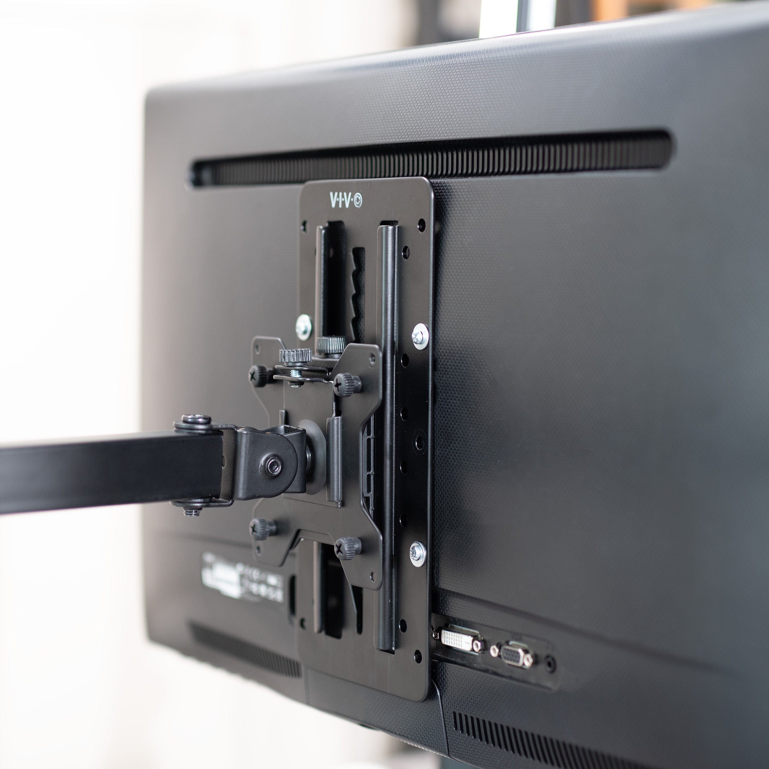 Monitor mount attached to a screen with visible brand logo.