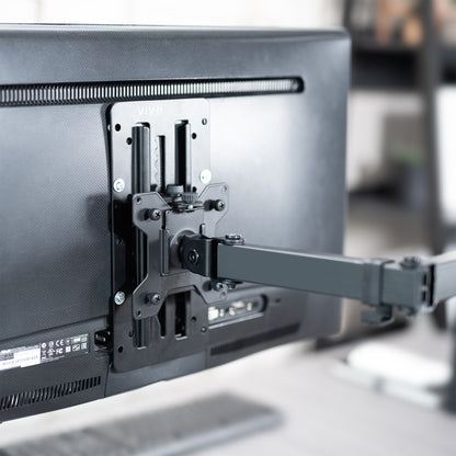 Monitor with a swivel arm attached, showing the mounting bracket.