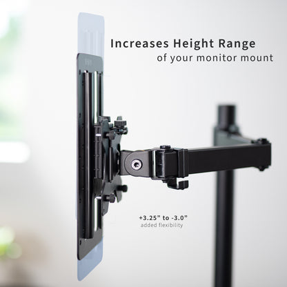 Height-adjustable Vesa adapter attached to a monitor on a desk with office background