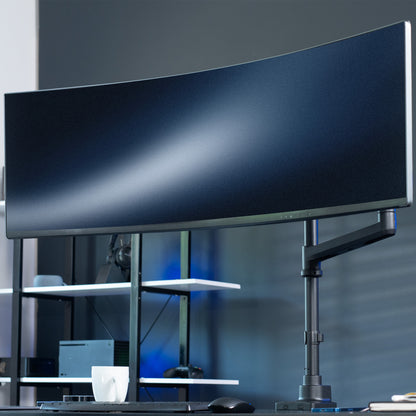Large monitor on a stand in a modern office setting.