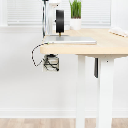 White under-desk cable management trays facing outwards.