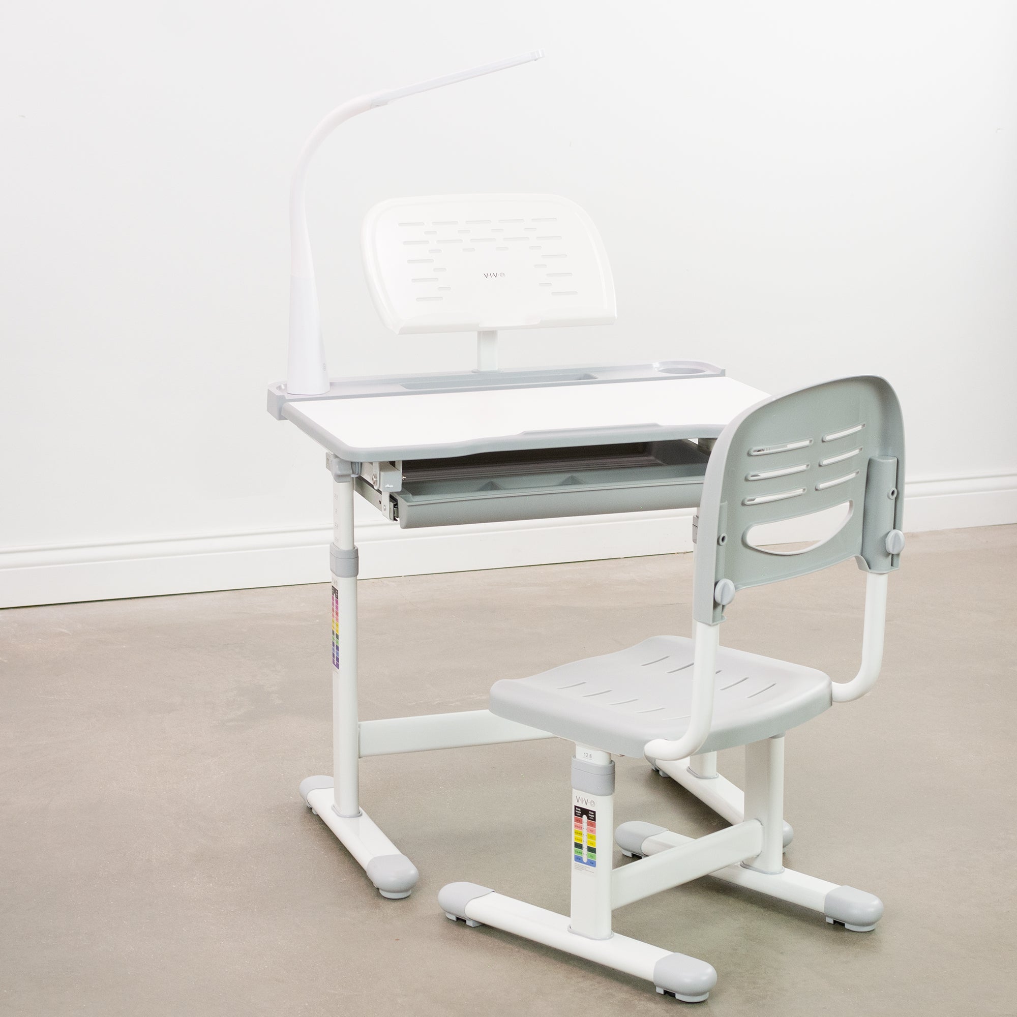 gray and white kids' height adjustable desk with chair