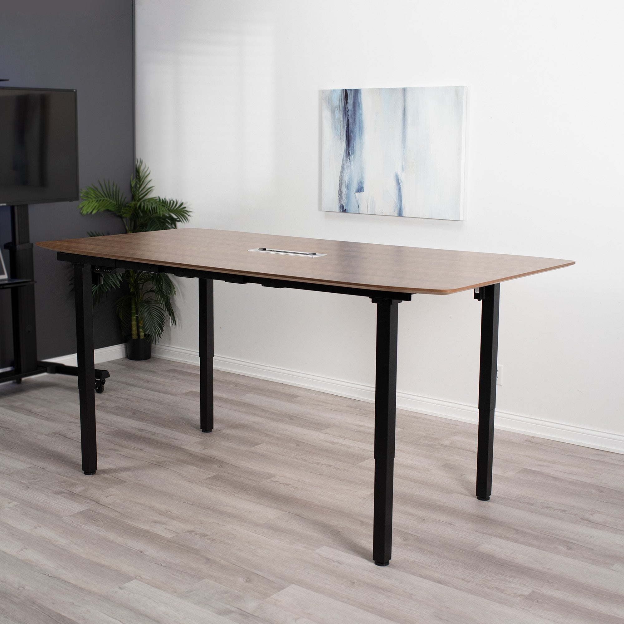 Conference room with a sit-to-stand electric frame and large table top.