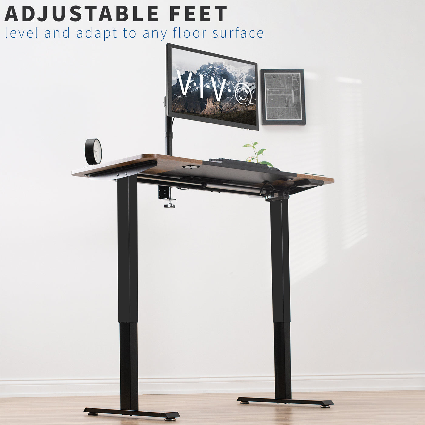 Ergonomic rustic electric sit or stand desk workstation with adaptable adjustable feet for base support.