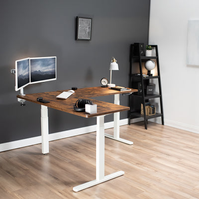 Heavy-duty rustic electric height adjustable corner desk workstation for active sit or stand efficient workspace.