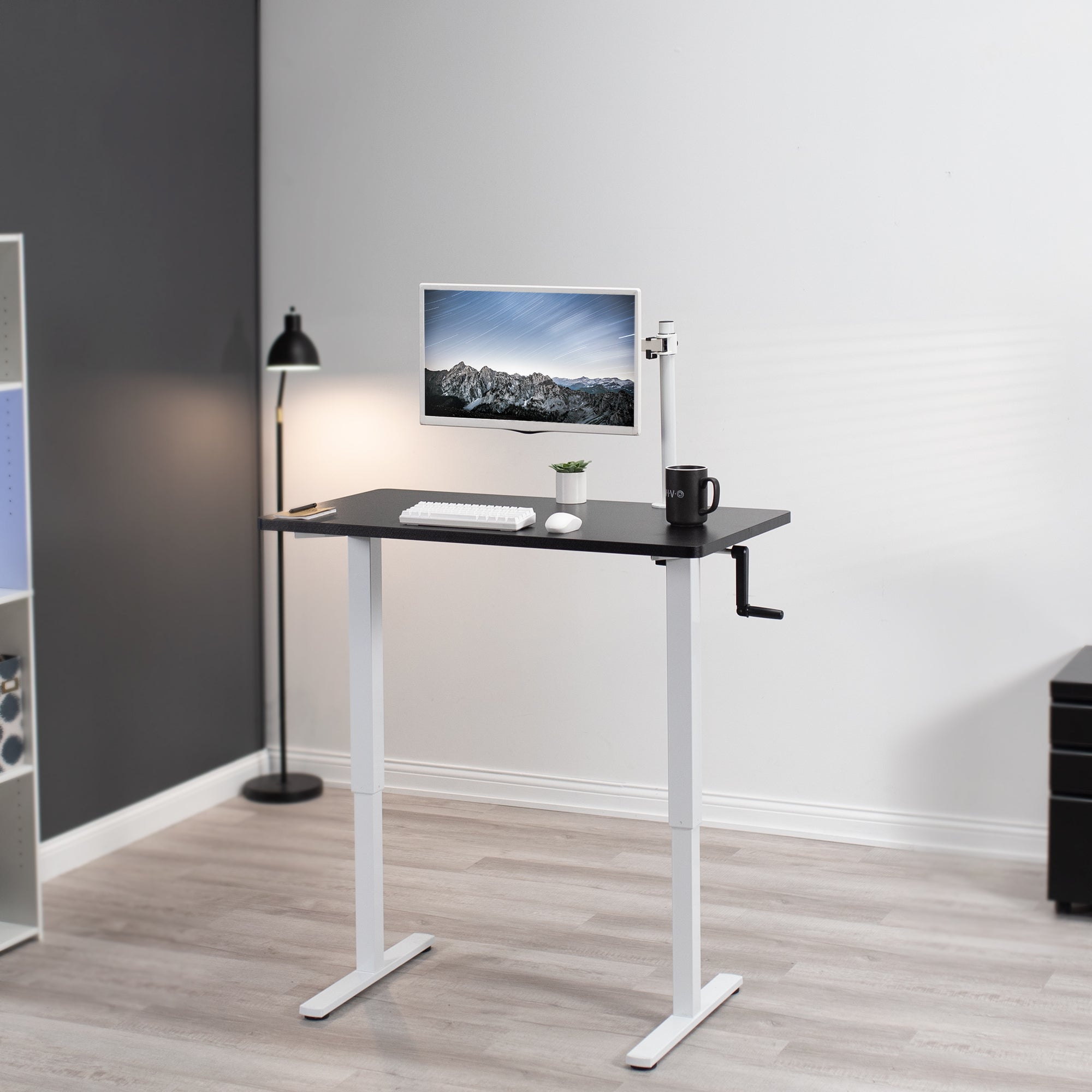 Manual hand crank height adjustable desk for active sit to stand workstation.