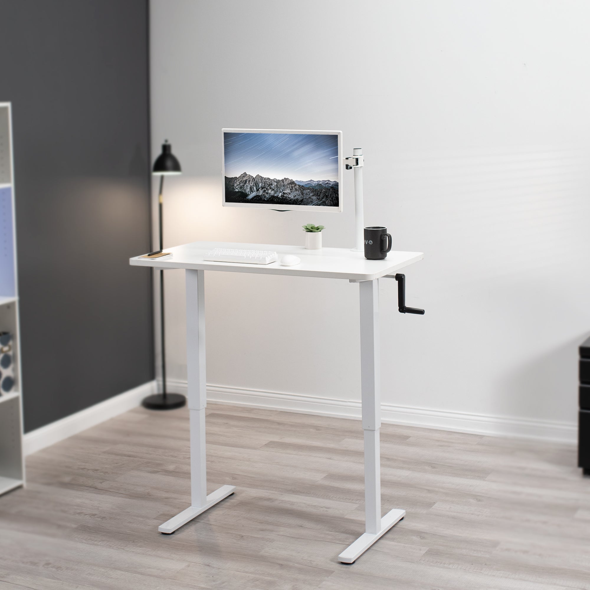 Manual hand crank height adjustable desk for active sit to stand workstation.