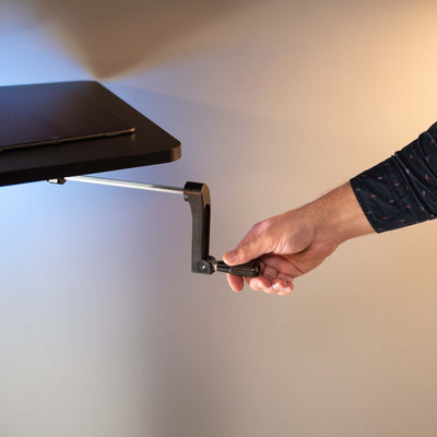 Heavy-duty adjustable height corner desk workstation with manual hand crank.