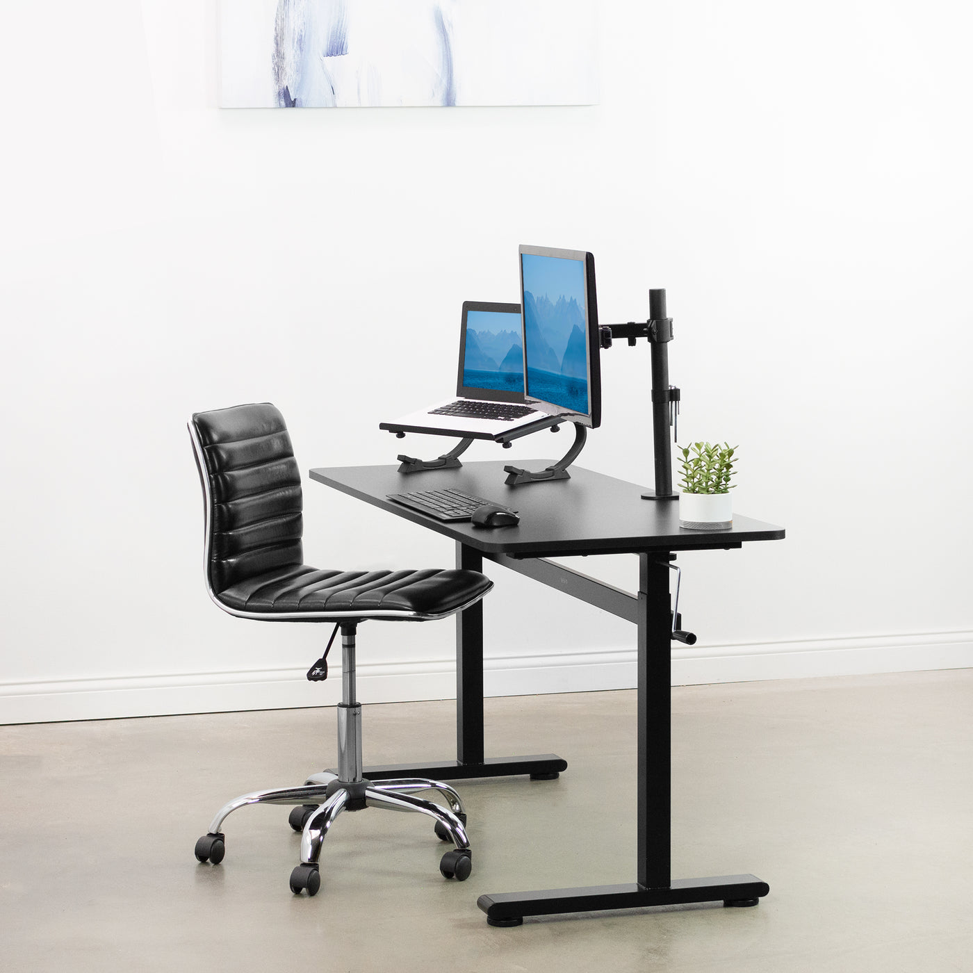 Manual crank desk in a minimalist office space.