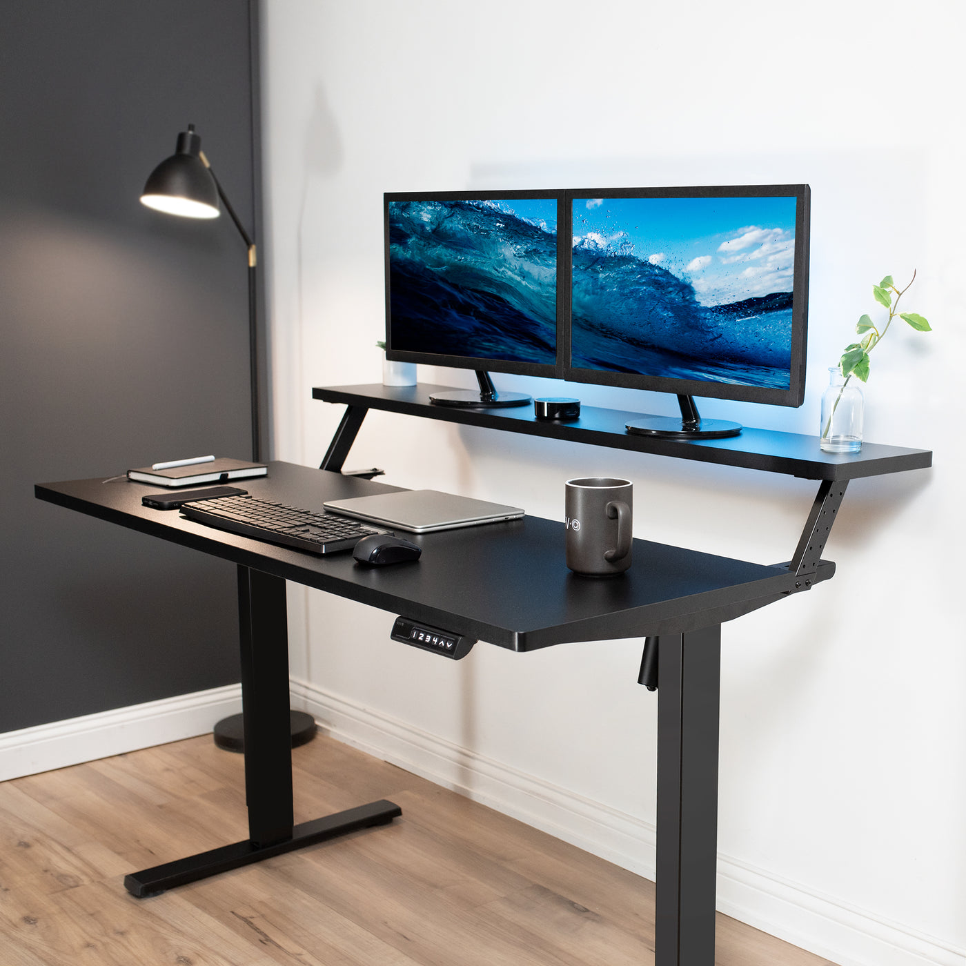 Heavy-duty adjustable sit or stand dual tier ergonomic office desk workstation.
