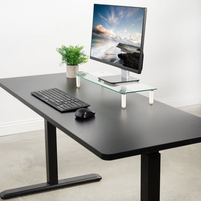 Electric black desk frame with a black particleboard top.