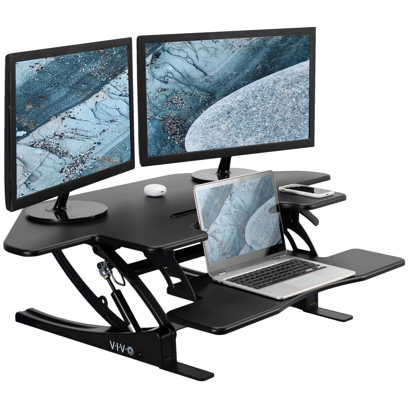  Two-tier tabletop desk riser with two monitors and a laptop.