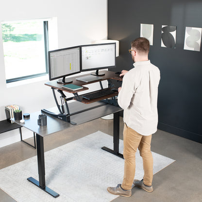 Heavy-duty height adjustable desk converter monitor riser with 2 tiers.