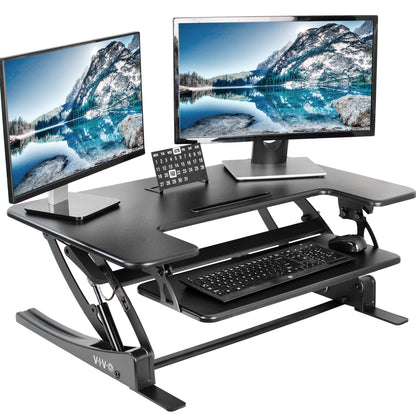 Heavy-duty height adjustable desk converter monitor riser with two tiers.