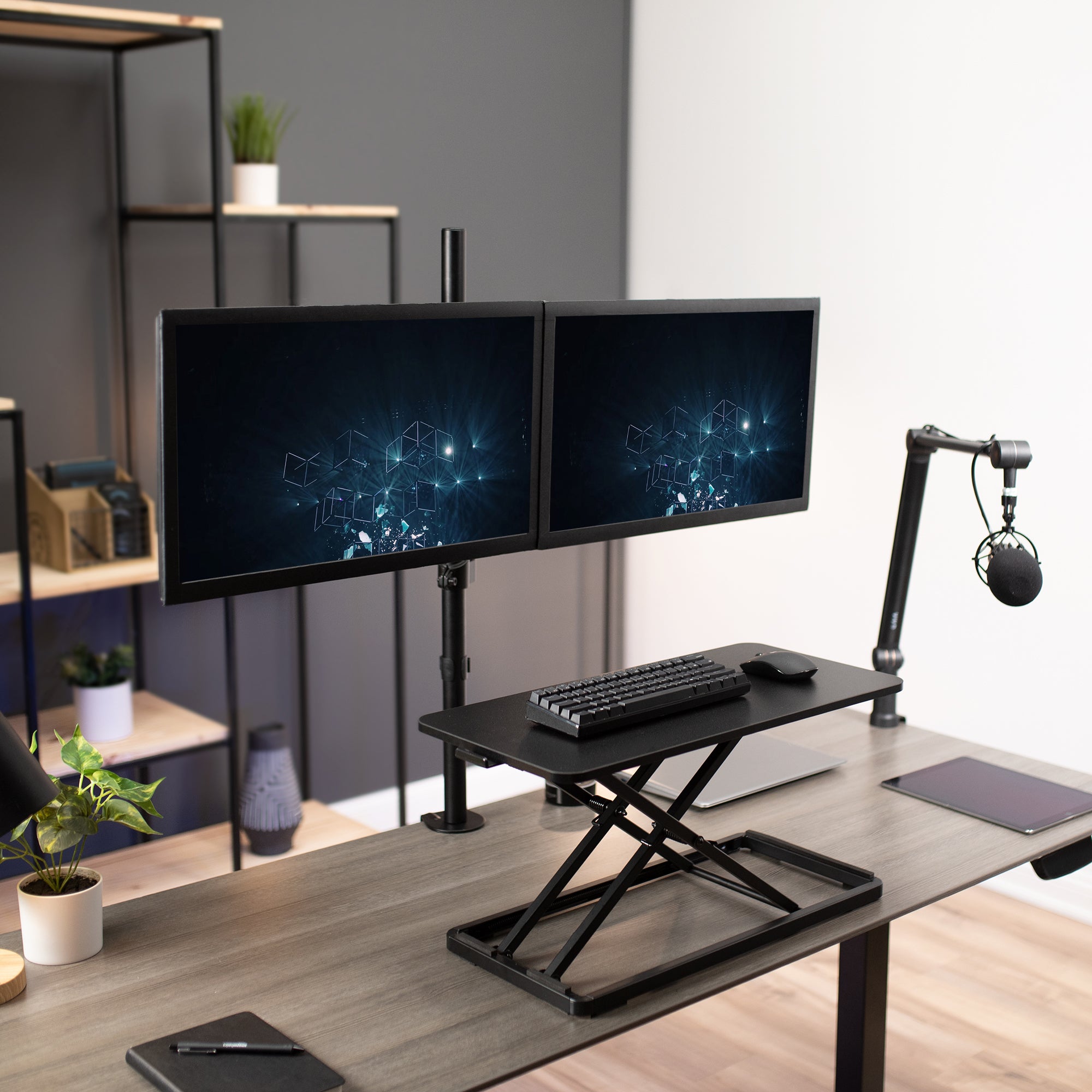 Dual monitor mount set up with an extending keyboard tray platform.