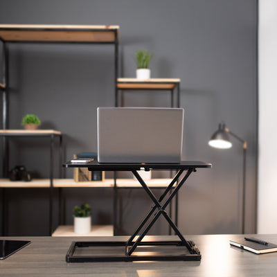 A laptop and phone safely elevated to work while standing.