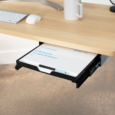 Reduce your desktop clutter and discreetly store important notes with this pull-out dry erase board.
