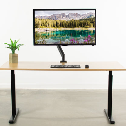 The strength of the VESA adapter is showcased with an extra large work monitor on the modern desk.