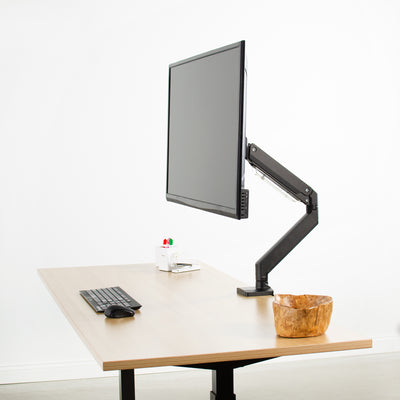 The strength of the VESA adapter is showcased with an extra large work monitor on the modern desk.