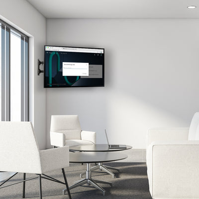 Modern office space with a corner wall-mounted TV for easy viewing.