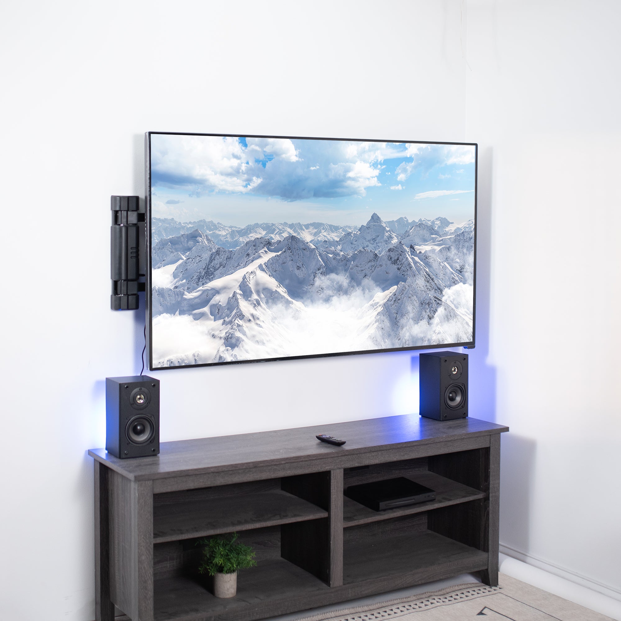 Modern office set up with mounted TV and a sound system.