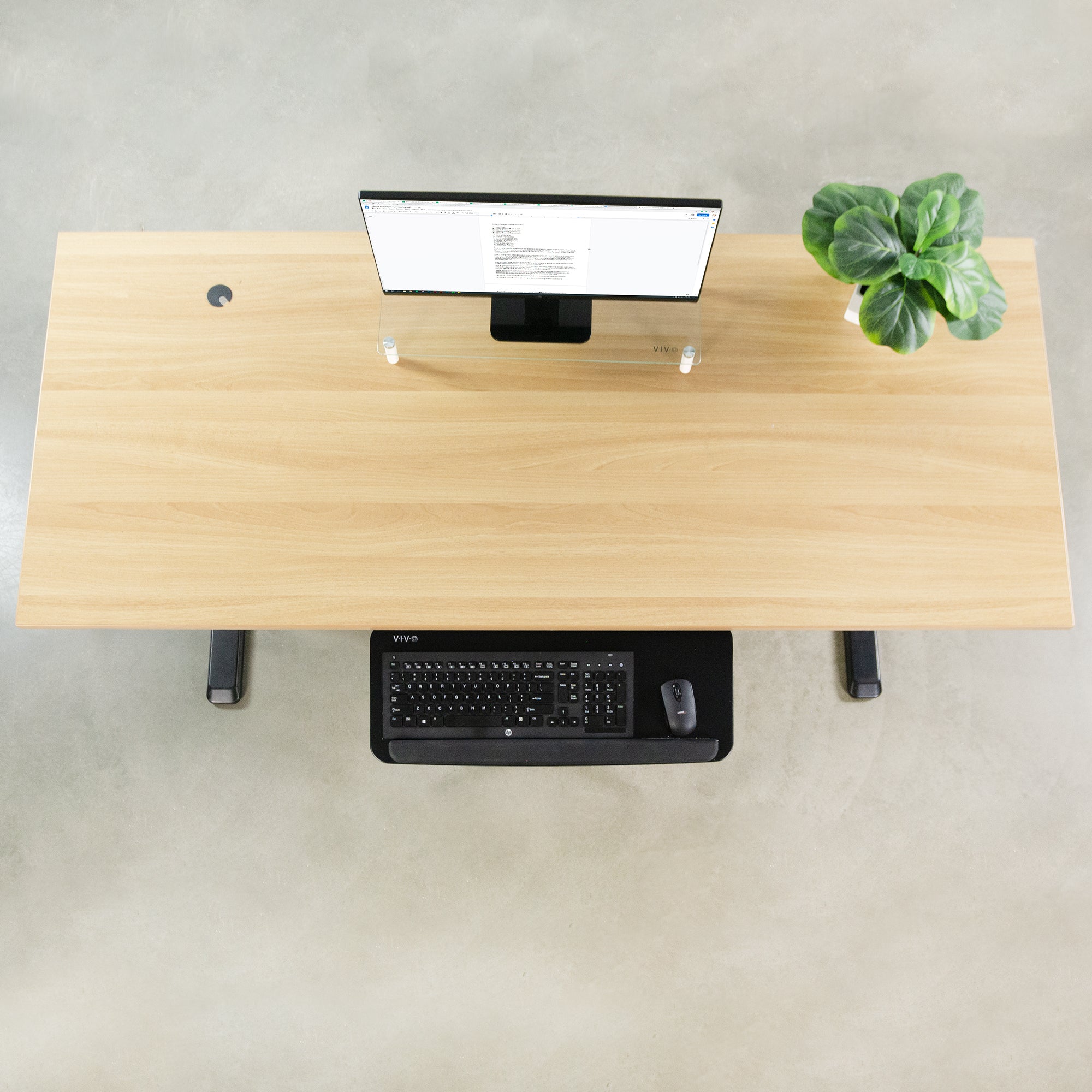 Clean desk with under desk keyboard tray holding keyboard and mouse.