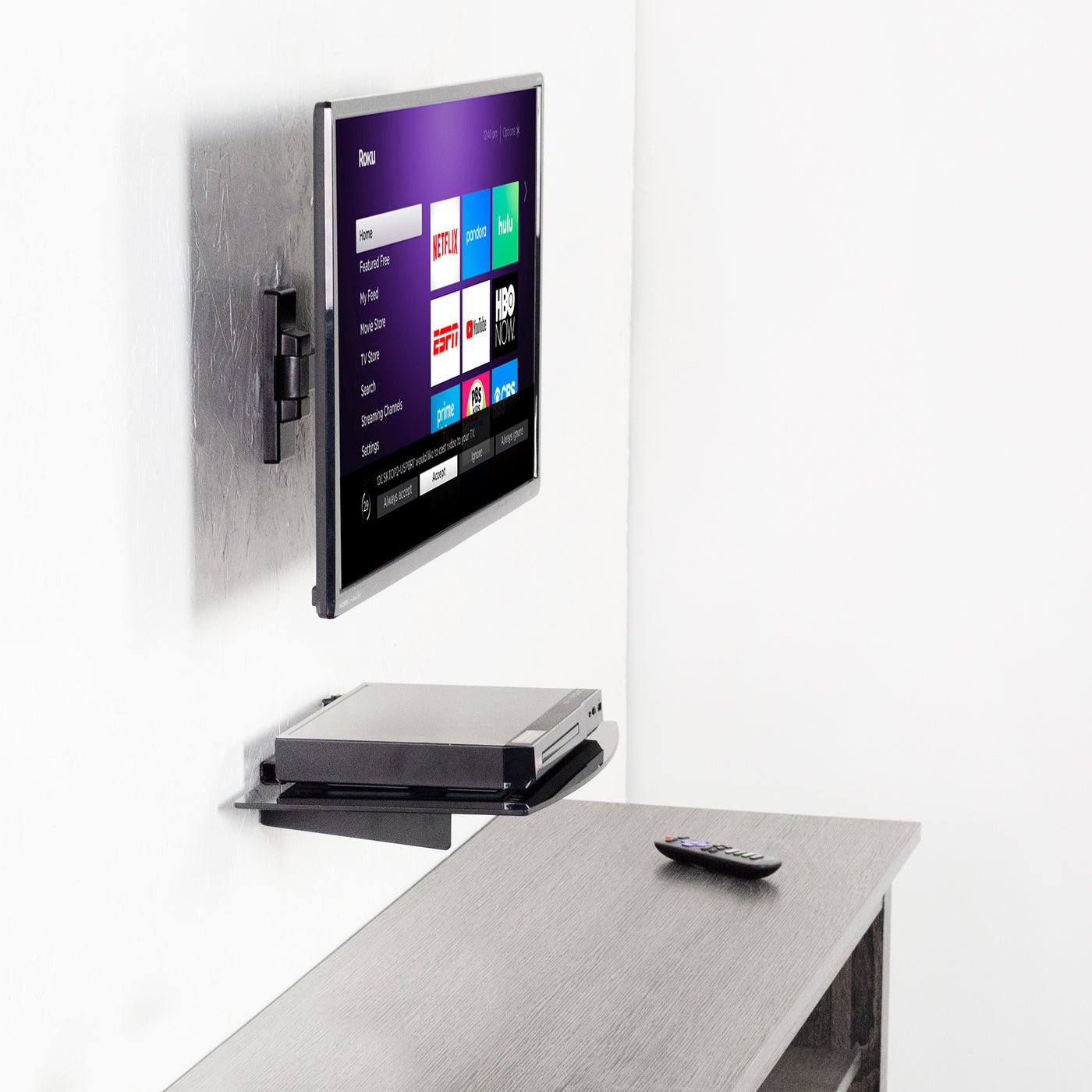 Roku TV and remote with a floating shelf.