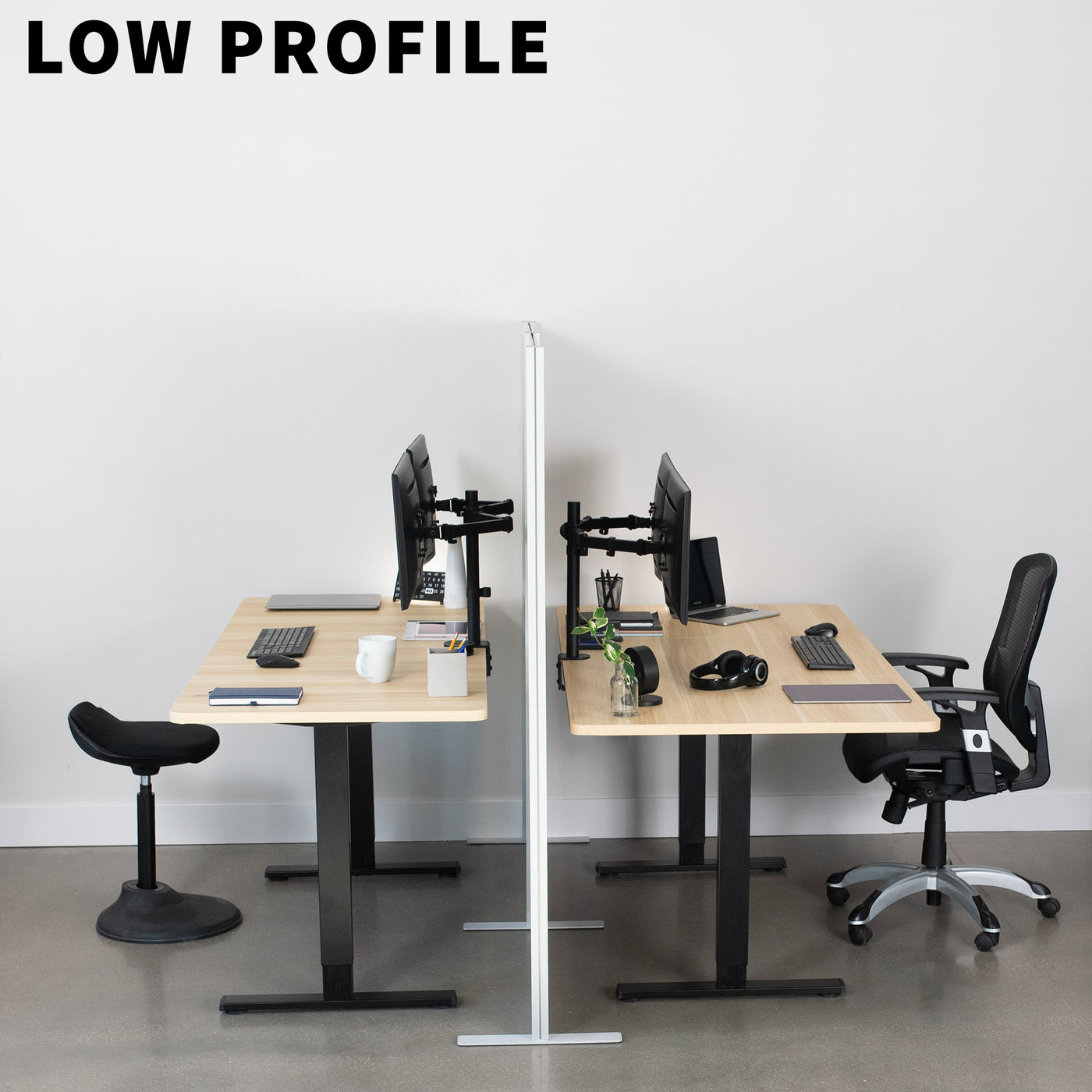 Low profile desk divider between two desks facing each other.