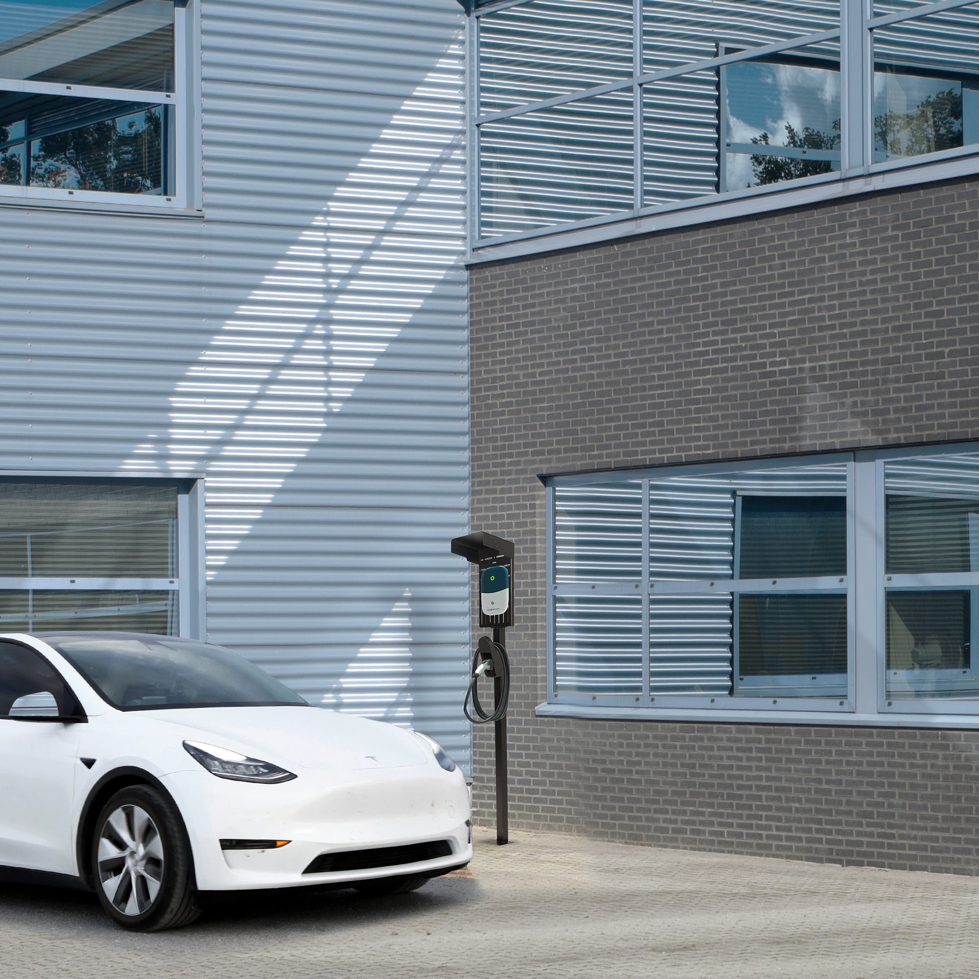 Sturdy steel-constructed EV charging station outside of a modern building.