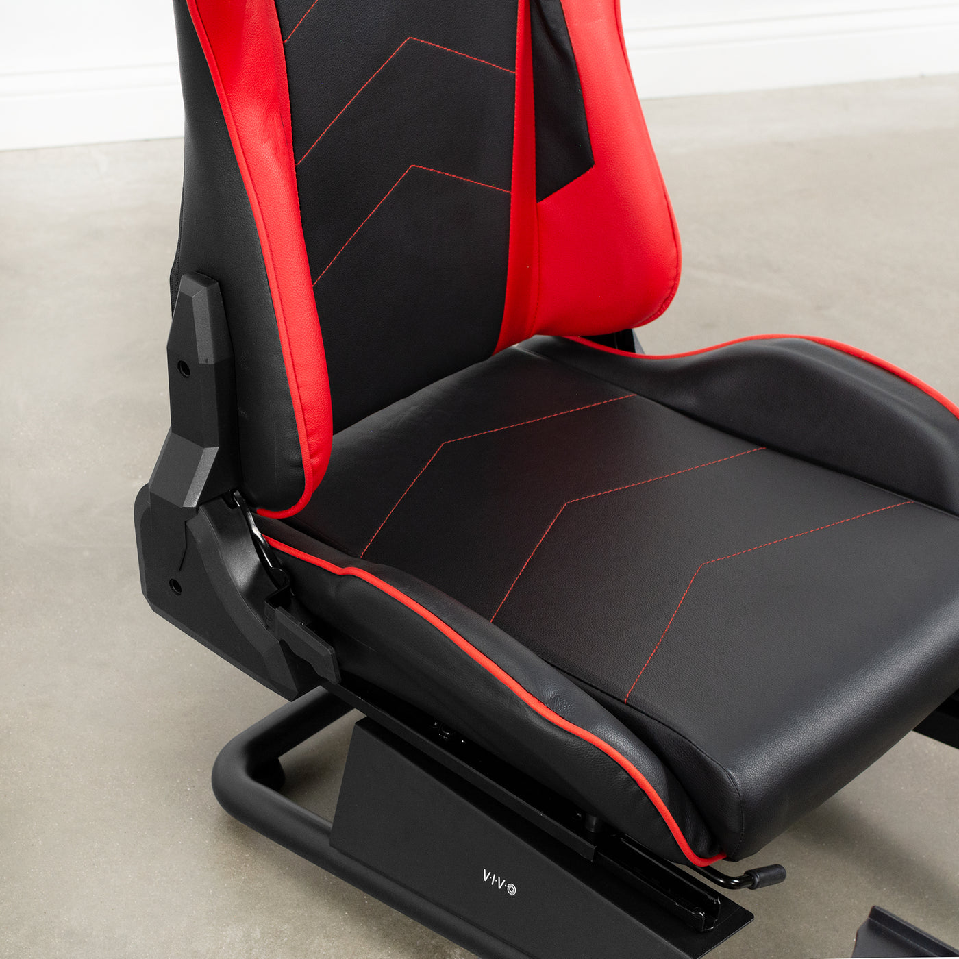 Red and black leather racing seat for gaming system set up. 