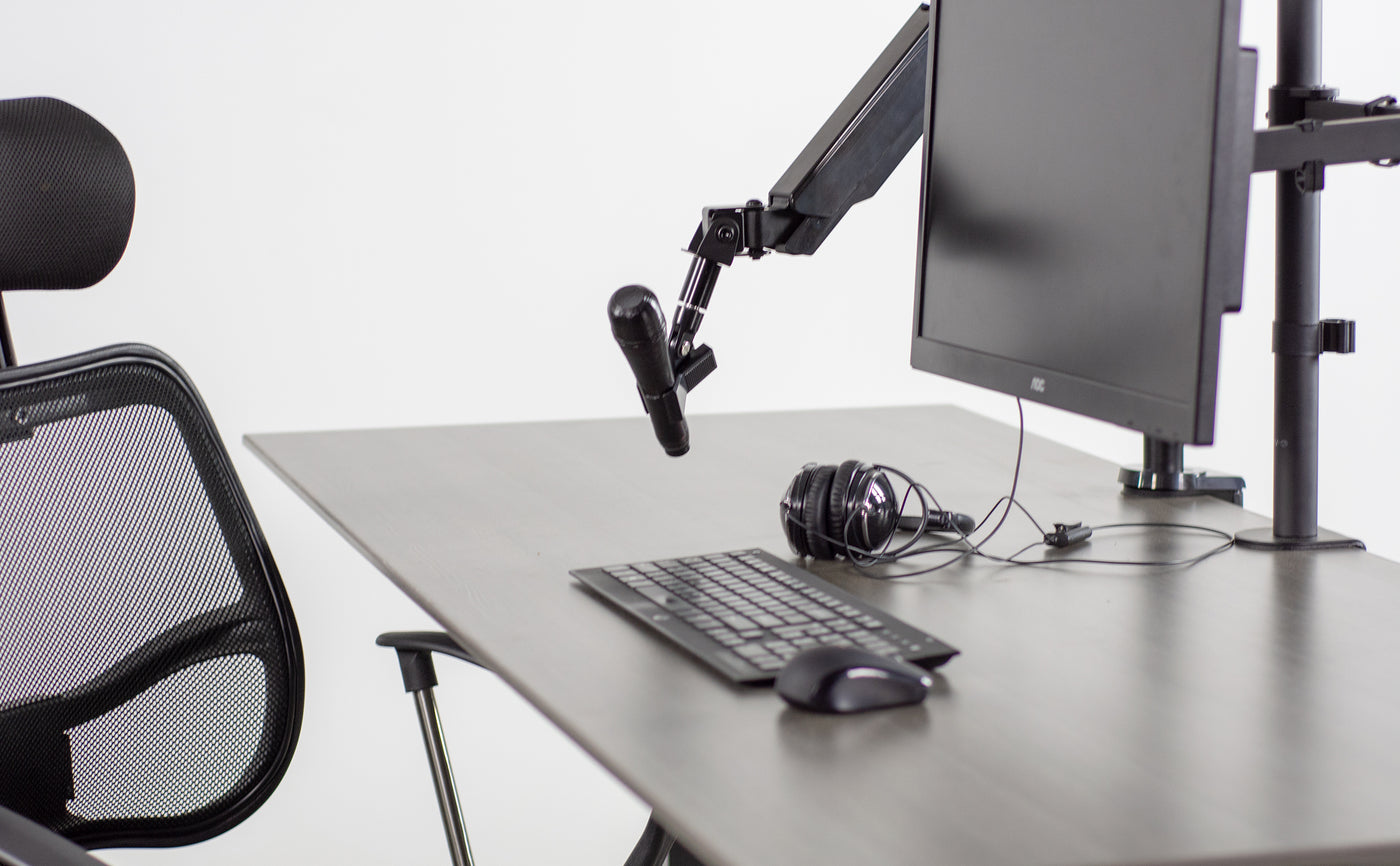 Minimalist desk space with microphone mount that can be adjusted depending on use.
